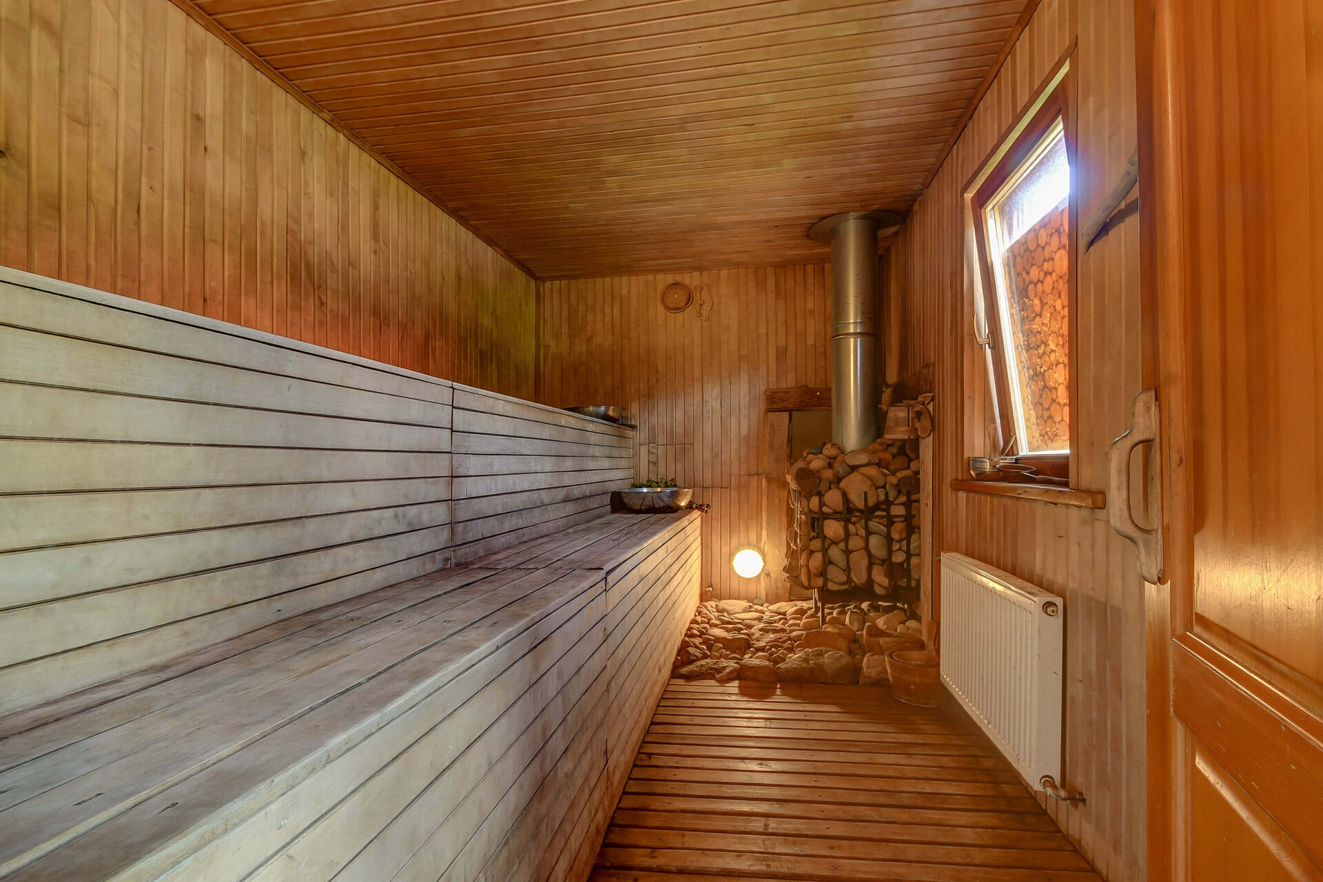 Sauna cabin by the pond in golden evening light