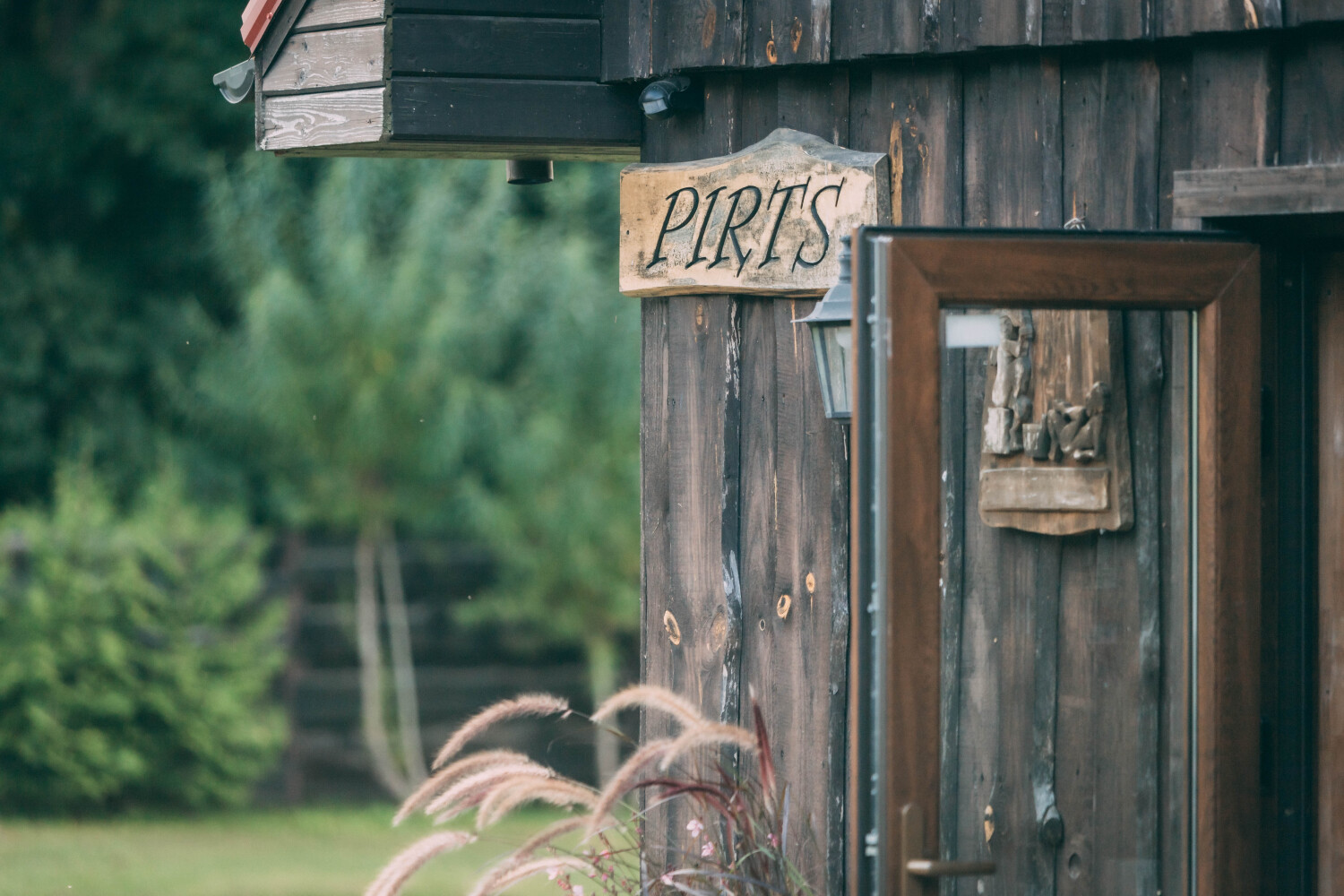 Close-up of the PIRTS sign at Vecmuiža sauna
